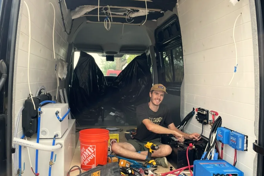 Zach wiring the electrical system in a van conversion